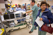 Canadian Healthcare / Toronto, Canada.

At 4:50 a.m. a rumpled lead physician, Najma Ahmed, fresh back from a few precious minutes in bed, scans the trauma room before rushing her patient off to surgery.